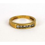 A 14ct yellow gold band ring set six small diamonds in a channel setting, ring size L, 2.