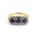 An 18ct yellow gold ring set three sapphire and diamond clusters, ring size O 1/2, 3.