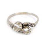 A platinum crossover ring set two brilliant cut diamonds,