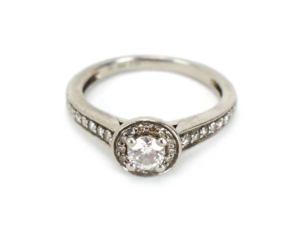 A platinum 'halo' ring set centrally with a brilliant cut diamond within a border of smaller