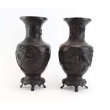 A pair of Japanese brown patinated bronze vases of baluster form,