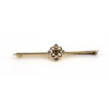 An early 20th century yellow and white metal highlighted bar brooch set five small diamonds and