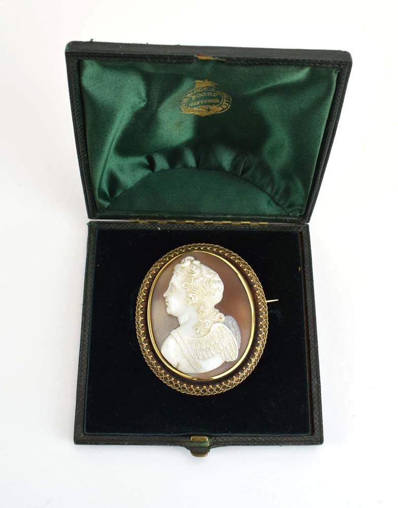 A late 19th/early 20th century yellow metal mounted cameo brooch of oval form carved with a putto, - Image 2 of 4