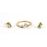 A 9ct yellow gold crossover ring set paraiba tourmaline and diamond,
