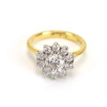 An 18ct yellow gold ring set eleven brilliant cut diamonds in a flowerhead setting,