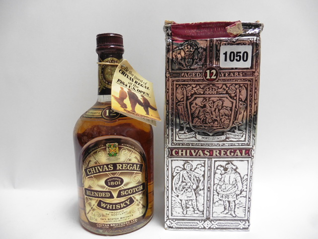 An old bottle of Chivas Regal 12 year old Scotch Whisky with box advertising the 1984 US Open 75