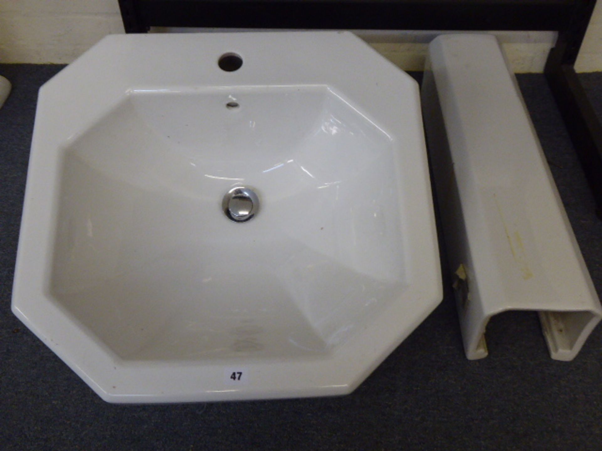 A traditional white ceramic wash basin and pedestal