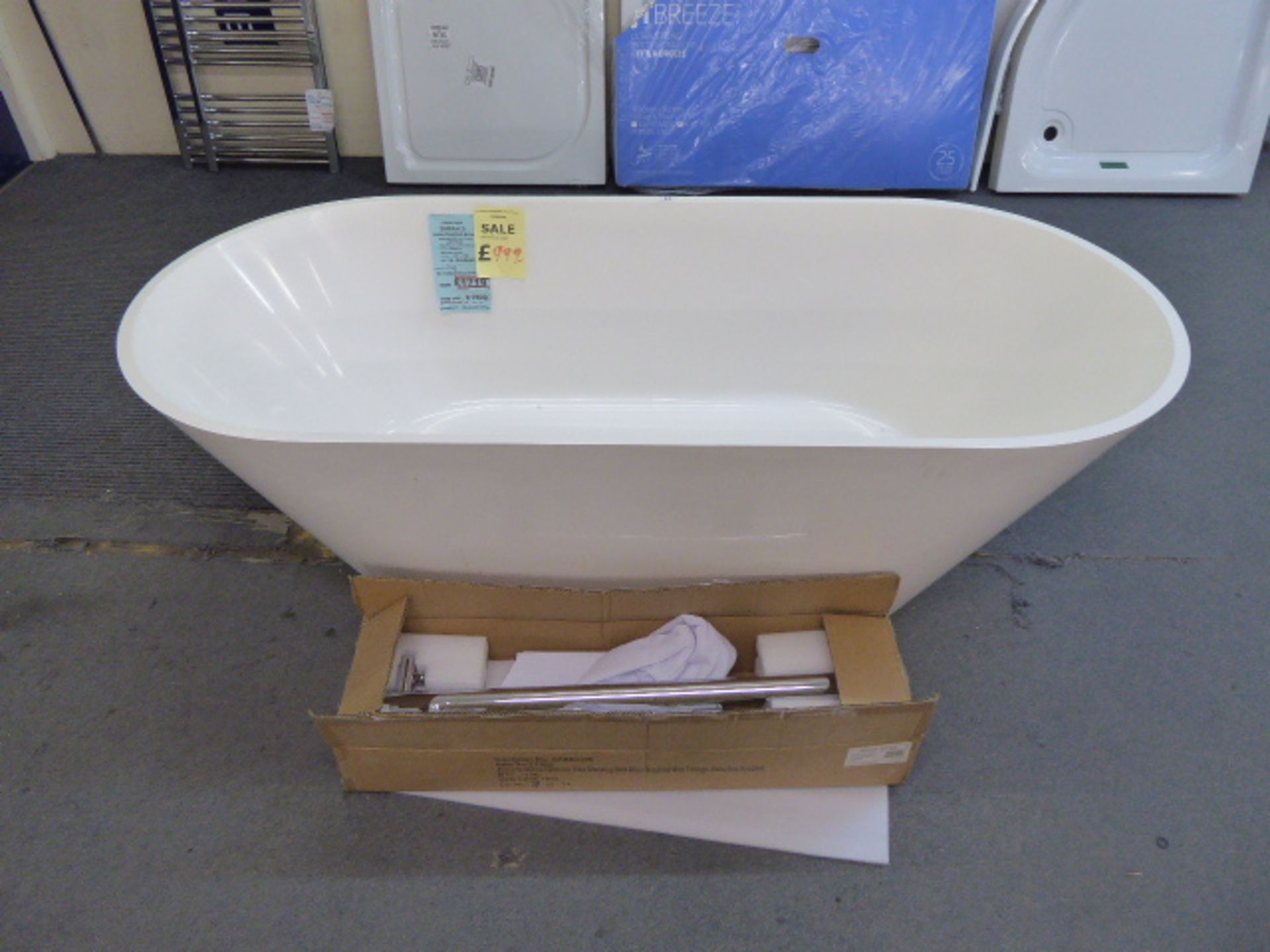 Gemstone Emerald free standing bath in volcanic limestone together with upstand and bath mixer