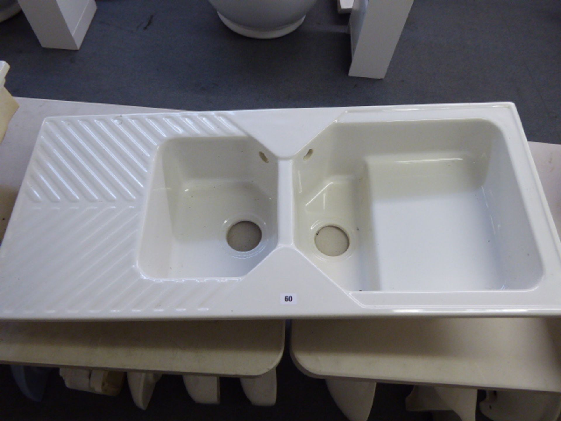 A white ceramic one and a half bowl inset sink unit