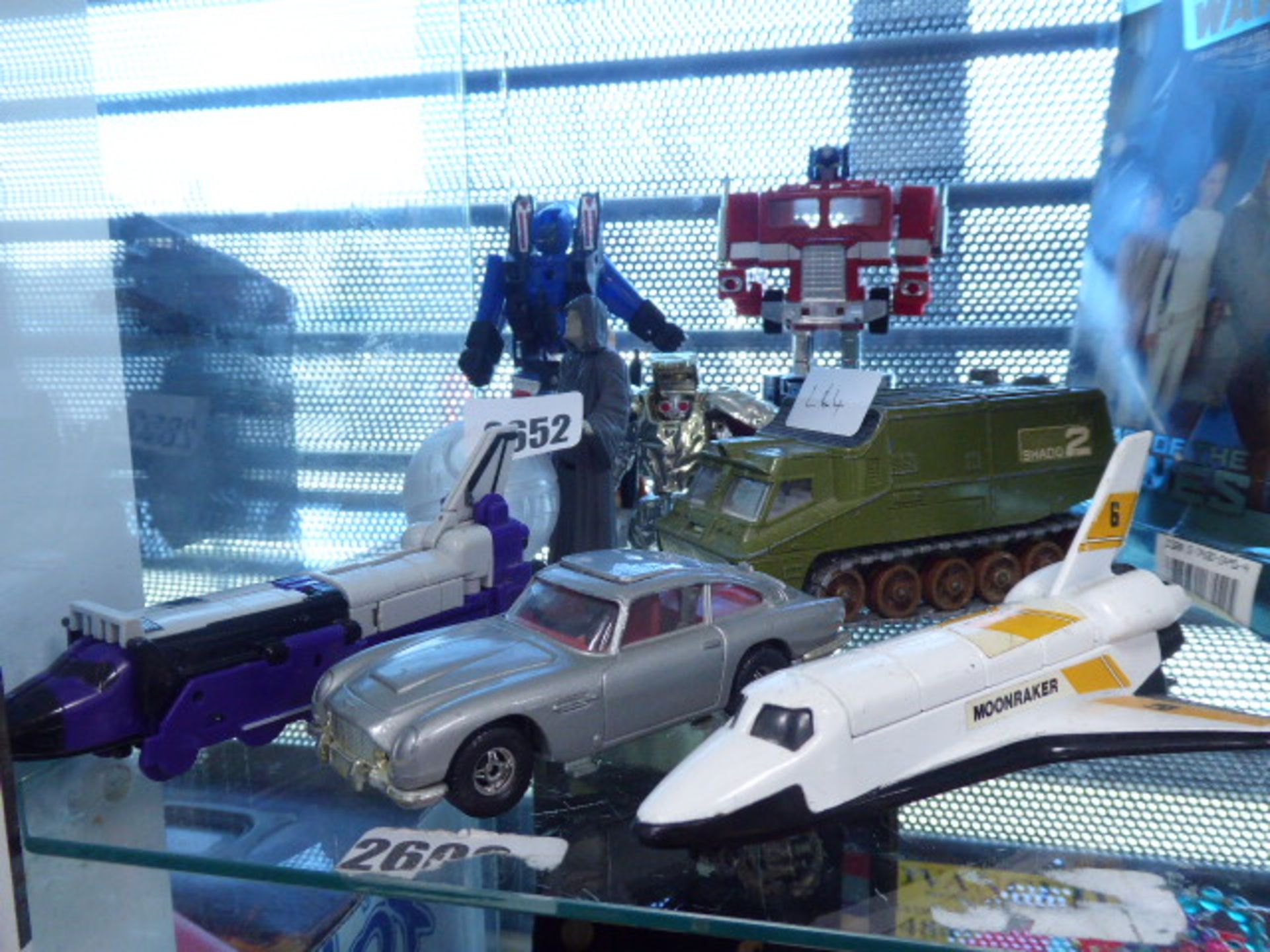 Selection of collectible toys and die cast vehicles including Transformers, Corgi, 007 Aston