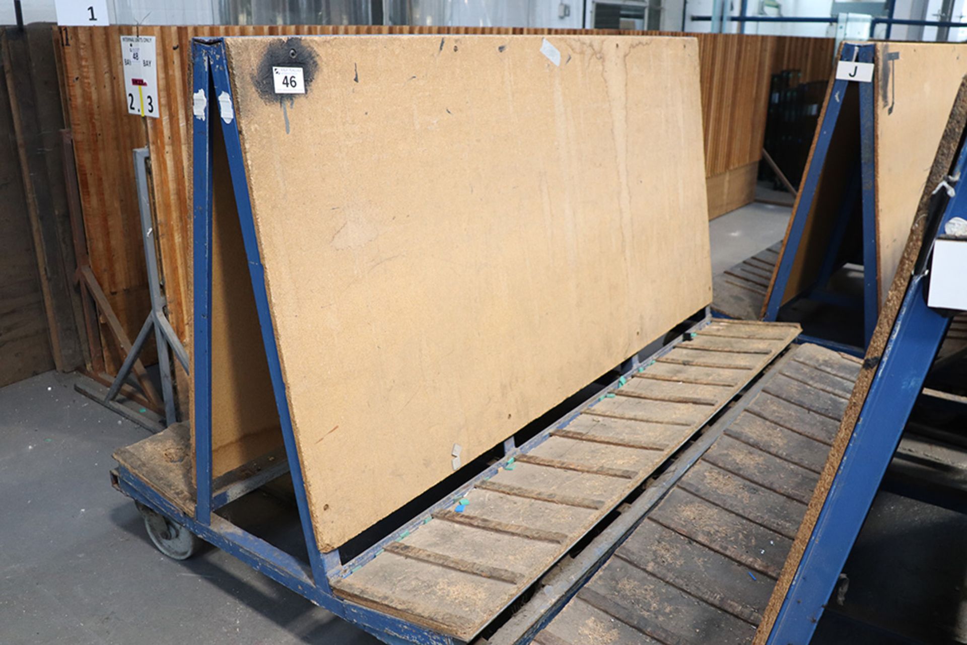 Welded steel and chipboard double sided stock trolley (approx 2 metres long x 1 metre high)