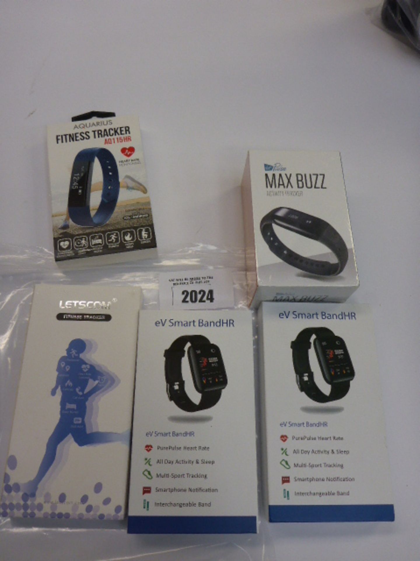 Bag of fitness tracking accessories by, Virgin Pulse, Letscom, and Aquarius.