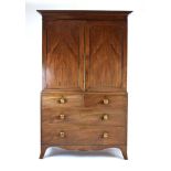 An early 19th century mahogany linen press having a pair of drawers above two short and two long