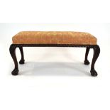 A Victorian walnut duet stool on claw and ball feet, w.