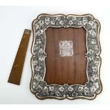A Greek metalware mounted easel back photograph frame decorated with fruiting vines, h.