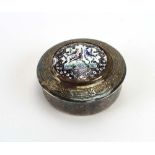 A Middle Eastern metalware and enamelled box and cover of circular form centrally decorated with