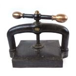 Cast Iron Book Press with a Brass Finial and Turning Handles.
