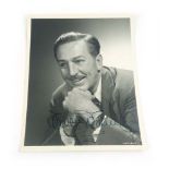 Walt Disney : Large format monochrome studio photograph bearing signature at the lower margin.