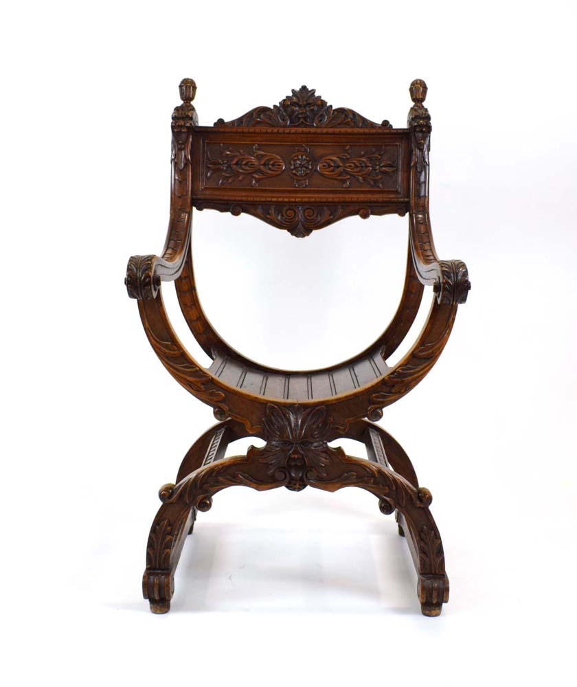 A continental walnut throne-type chair carved with stylised figures and foliate motifs, h.