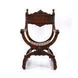 A continental walnut throne-type chair carved with stylised figures and foliate motifs, h.
