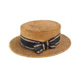 A straw boater by Battersby, London decorated with a ribbon in the 'suffragette' colours,