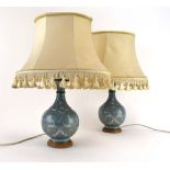 A pair of Chinese cloisonne table lamps, each decorated with foliate scrolls on a pale blue ground,