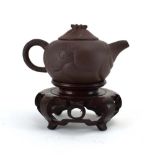 A Yixing miniature teapot relief decorated with dragons and having an articulated dragon vent,