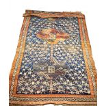 A Turkish carpet with three linked medallions in a cobalt blue lattice work field within an orange