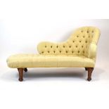 A Victorian pale yellow button upholstered chaise on walnut feet, w.