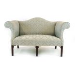 A Georgian and later wing backed two seater settee upholstered in a pale green damask-type fabric