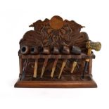 An early 20th century hardwood pipe rack modelled in the Oriental manner,