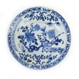 An 18th century Chinese blue and white shallow dish decorated with blossoming shrubs, d.