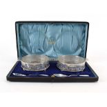 A cased pair of early 20th century pierced silver mounted butter dishes, Walker & Hall,