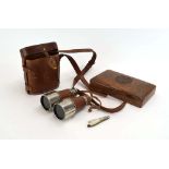 A pair of French stainless steel binoculars in a leather case,