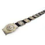 An Edwardian silver eighteen section belt,