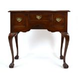 An 18th century-style mahogany lowboy having three frieze drawers on cabriole claw and ball feet, w.