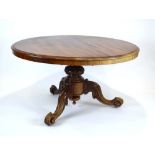 A Victorian mahogany breakfast table, the circular surface above a tripod base of Rococo design, d.