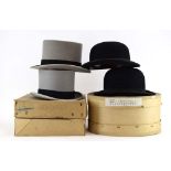 A group of hats including two grey silk top hats by Woodrow and Moss Bros.