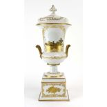 A 19th century two handled covered urn, gilt decorated with travelling figures on a white ground, h.