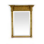 A Regency-style gilt pier mirror of rectangular form with lattice work decoration within columnar