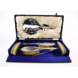 A cased seven piece silver dressing table set,