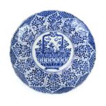 A Kangxi blue and white charger centrally decorated with a basket of flowers within a scalloped