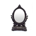 A black patinated cast metal dressing table mirror of oval form in the Art Nouveau manner, h. 60.