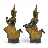 A pair of Far Eastern green patinated and gilt decorated bronze figures modelled as a dancing