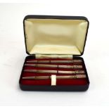 A cased set of four metalware and engine turned bridge pencils,