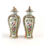 A pair of Cantonese covered vases of baluster form,