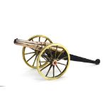 A copper and brass model of a 19th century cannon and gun carriage, l. 33 cm (cannon), d.