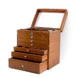 A vintage dentistry cabinet, the mahogany box with a handle, lift lid and six graduated drawers, h.