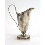 An Edwardian silver cream jug of helmet form on a square foot, maker GU, Birmingham 1907, h.