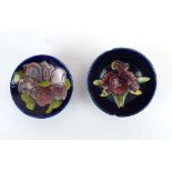 A miniature Moorcroft dish decorated with anemone on a shaded blue ground, d.